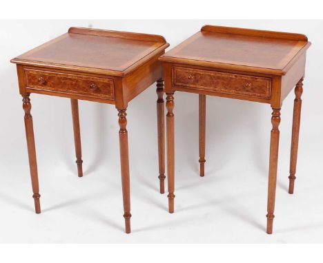 A pair of walnut and satinwood crossbanded lamp tables, each having a rectangular top above a single drawer, raised on slende