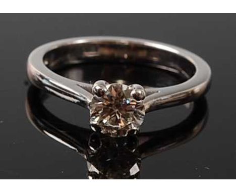 An 18ct white gold diamond solitaire ring, featuring a round brilliant cut diamond in a four-claw setting, diamond dimensions