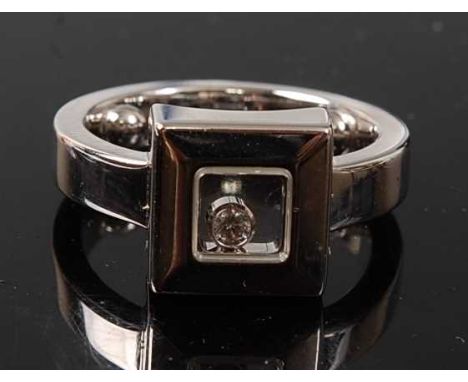 An 18ct white gold Happy Diamond ring by Chopard, comprising a 9.9mm square head with a 2.2mm floating round brilliant cut di