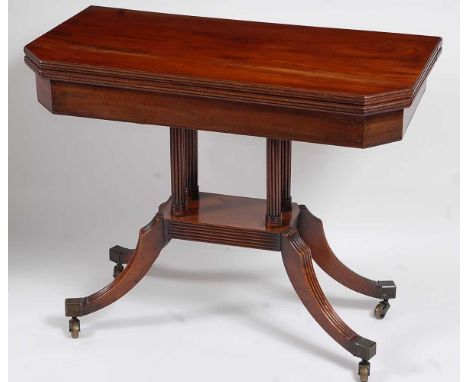 A Regency mahogany card table, the rectangular fold-over top with canted corners opening to reveal a baize lined playing surf