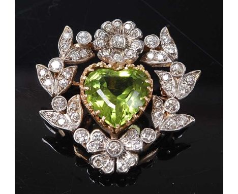 A yellow and white metal, peridot and diamond floral brooch, featuring a centre heart shaped peridot within a diamond set flo