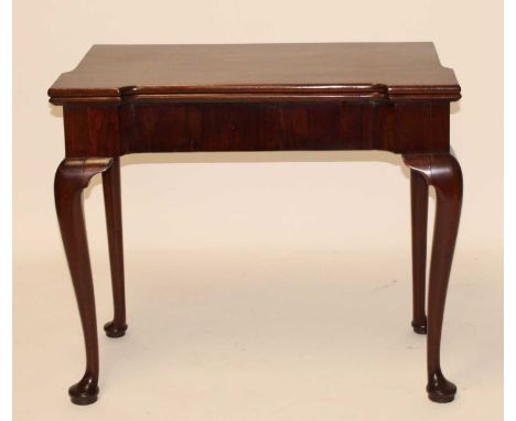 A George III mahogany card table, the fold-over top with proud corners, on single gateleg rear action and opening to reveal b