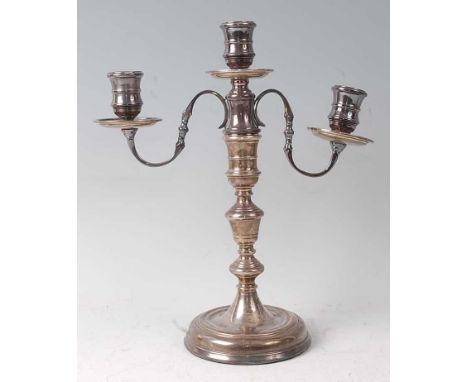 A silver three-light candelabrum, in the early 18th century style, having detachable sconce and on multi-knopped stem to a lo
