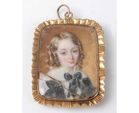 An early 19th century yellow metal miniature portrait memorial pendant, depicting a child's profile with a lock of hair to th