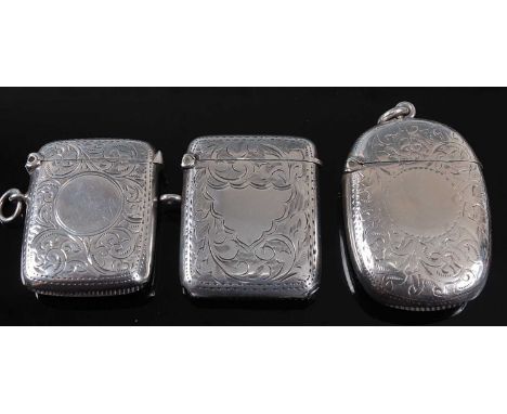An Edwardian silver vesta, of hinged rectangular form, having all-over foliate engraved decoration and vacant circular cartou