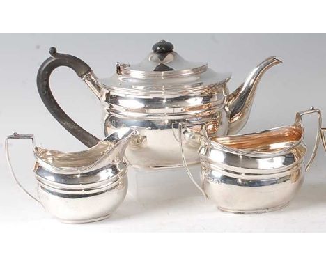 A silver three-piece tea set, in the early 19th century style, comprising teapot, twin handled sugar and cream, each of oval 