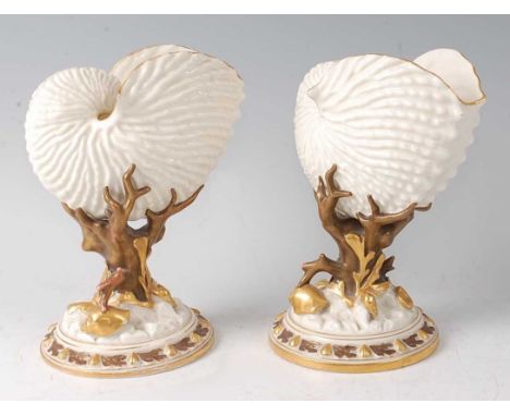 A pair of Royal Worcester porcelain Nautilus shell vases, each on bronzed and gilded moulded bases, impressed and printed gre