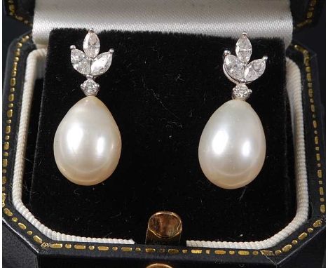 A pair of white metal, pearl and diamond drop earrings, the earrings each featuring a pearl drop measuring 13.5 x 10.1mm, sus