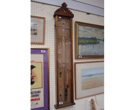 An Admiral Fitzroy wall barometer in a oak case. 107cm in Length 