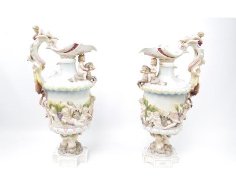 A Pair of 19thC Sitzendorf porcelain Renaissance style ewers, modelled with putti and satyr handles, blue painted marks, 36cm