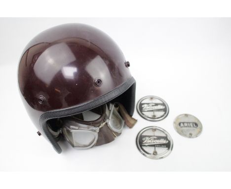 A vintage 1960s Ariel motorcycle Helmet with a pair of period Stadium racing goggles, Ariel &amp; Velocette motorcycle tank b