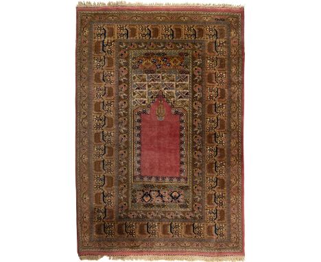 * Carpet. A Turkish prayer rug, Hereke, circa 1930s, hand-knotted silk rug, with central prayer niche and suspended lamp with