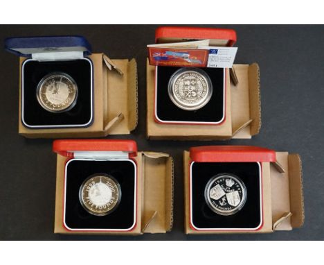 A collection of four Royal Mint United Kingdom silver proof crown and £5 coins to include the 2000 Millennium £5 coin (x2), 4