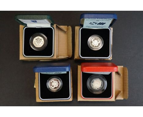 A collection of four Royal Mint United Kingdom silver proof coins to include two 1986 Commonwealth games £2 coins, 1998 25th 