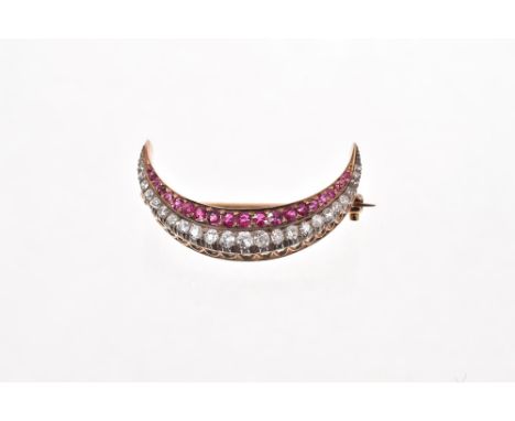 Victorian ruby and diamond crescent brooch with a row of graduated rubies and old cut diamonds in silver and gold setting wit