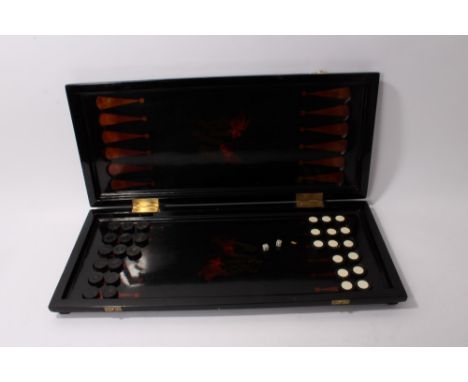 Chinese lacquer games board, folding form, with chequerboard top painted with carp, the underside with backgammon and ivory d