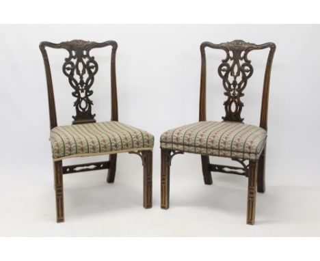 Elaborate pair of Chippendale-style side chairs, each with ornately carved vase splat back and embroidered stuffover seat on 