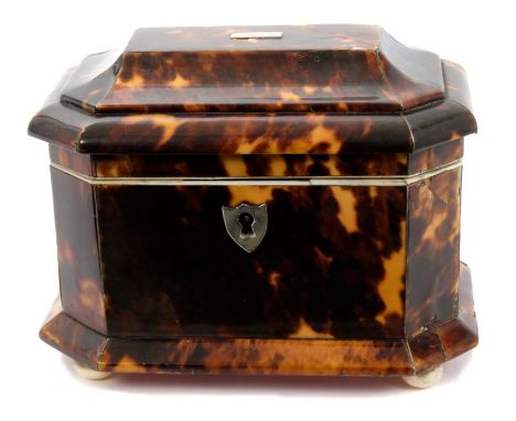 George IV tortoiseshell tea caddy of small size sarcophagus form, with hinged lid enclosing cover and twin compartments on sq
