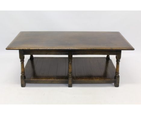 17th century revival oak coffee table with moulded rectangular top on turned supports and plank shelf below, 122cm wide x 52c