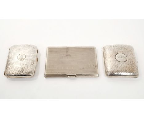 Two Edwardian silver cigarette cases of shaped rectangular form, with spot-hammered finish and engraved initials (Birmingham 