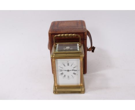Early 20th century French carriage clock in brass case with white enamel dial and eight day movement, 18cm high, with leather