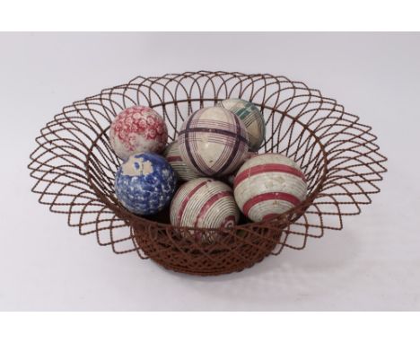 Set of eight 19th century Scottish polychrome painted ceramic carpet bowls, each approximately 9cm diameter, in wirework bask