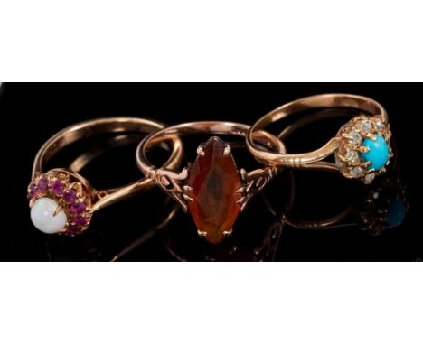 Three gold and gem set dress rings to include an opal and ruby cluster ring, a turquoise and diamond cluster ring and one oth