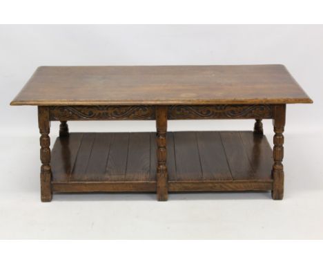 17th century style carved oak coffee table with rectangular top on scroll carved frieze and column supports united by shelf b