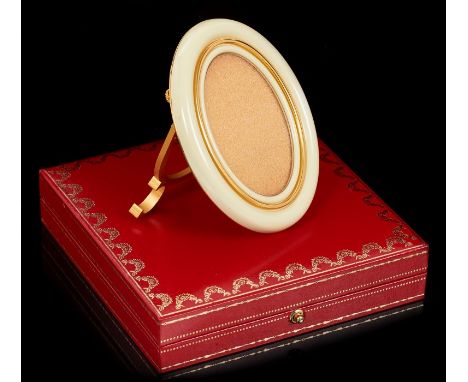 Cartier les Must de Cartier oval photograph frame with ivory enamel and gold decoration, signature 'C' scrolls to the easel s