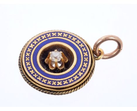 Victorian gold diamond and blue enamel pendant of circular form with a single old cut diamond within blue enamel and rope twi