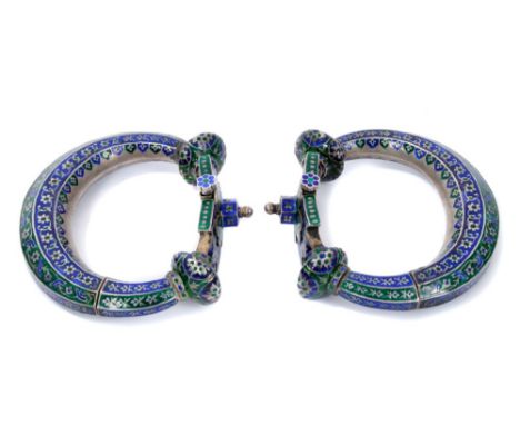 Pair of 19th century Indian silver and enamel anklets each with pin release and allover meandering floral ornament, 12cm wide