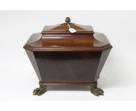 19th century Continental figured mahogany wine cooler of sarcophagus form, the hinged top with bud finial, with metal liner o