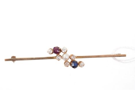 Edwardian bar brooch with a three-row diagonal cluster of old cut diamonds with a pearl, ruby and sapphire. 70mm length