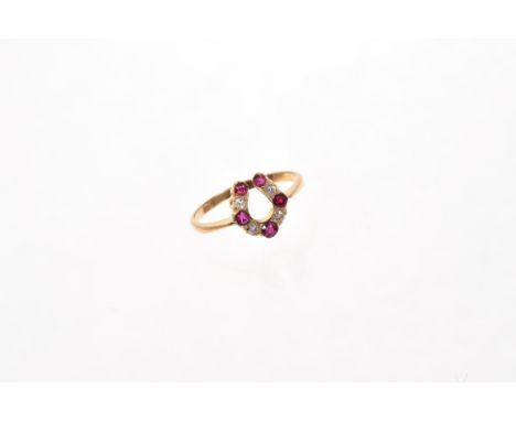 Unusual ruby and diamond ring in the form of a horseshoe, set with five rubies alternating with four old cut diamonds in gold