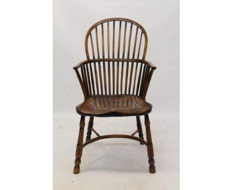 19th century yew and elm stick back Windsor chair arched back and saddle seat on turned legs and crinoline stretcher