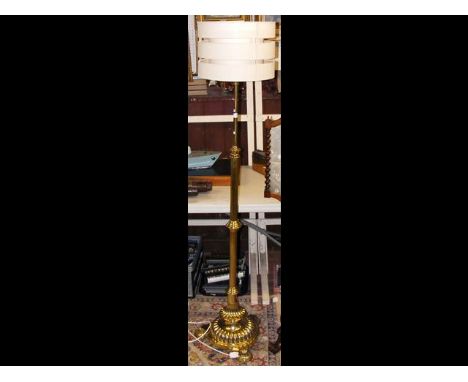 An attractive brass adjustable standard lamp on shaped support 
