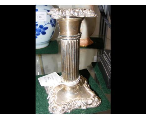 An 11cm high silver candlestick 