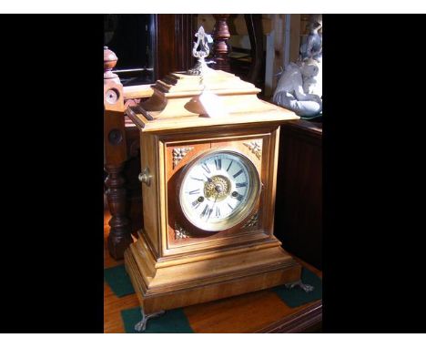 A 40cm high wooden cased striking mantel clock 
