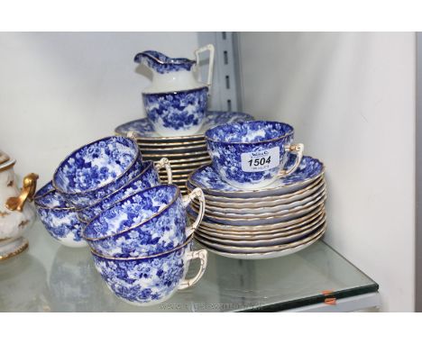 A blue and white part Tea Service comprising eight cups, twelve saucers, tea plates and milk jug