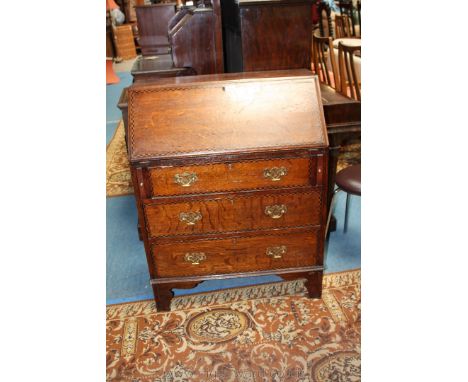 An Edwardian Oak country style Bureau, inlaid edge top, moulded and inlaid edge fall, opening to reveal seven pigeon holes an