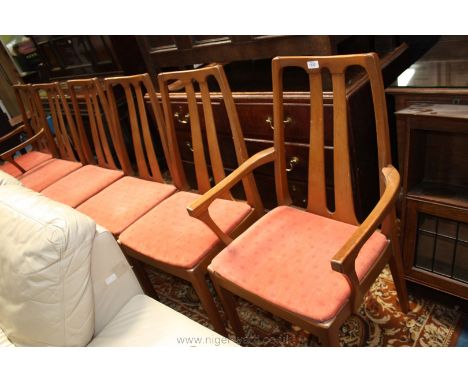 A modern set of light Beech Dining Chairs with pastel salmon coloured fabric seats, including two carvers 