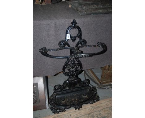 An ornate cast iron Stick Stand with pierced floral style splat back and foliage style scroll lower tray