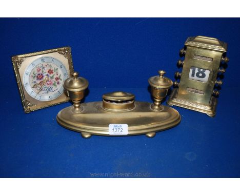 A Brass Desk Pen and Ink stand, a brass perpetual Calendar and a small Smiths dressing table Clock.