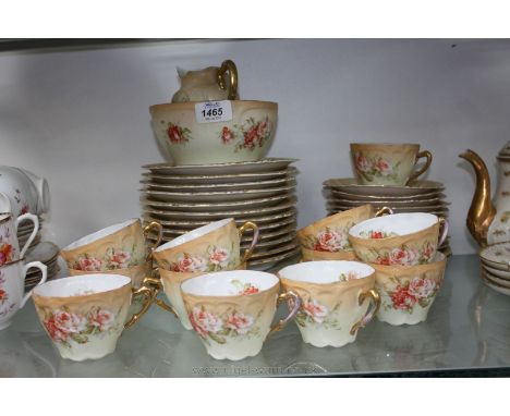 A continental porcelain Teaset, blush ground with floral pattern and gilt edging comprising twelve Cups and saucers, twelve T