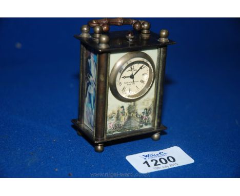 A small Omega Carriage Clock with portrait panels and scenic decoration.