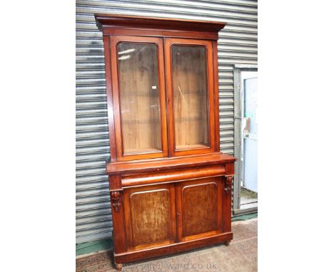 A good Victorian Mahogany Bookcase on Cupboard, moulded cornice over pair of opposing single pane glazed doors, opening to re