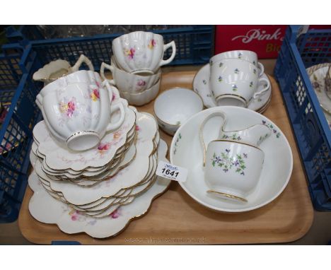 A very pretty part Bone China Teaset with scalloped edges and sprays of flowers comprising five cups, seven saucers and tea p