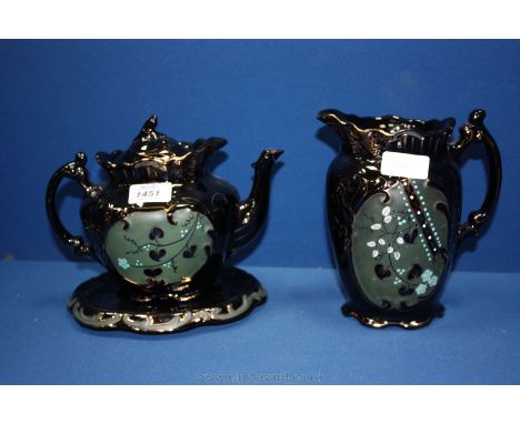 A Victorian Teapot, stand and lidded Hot Water Jug in black with gold detail and green panels with floral and foliage decorat