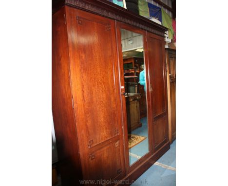 A good Victorian Mahogany triple door Wardrobe, having moulded cornice with applied moulded frieze, central full length mirro