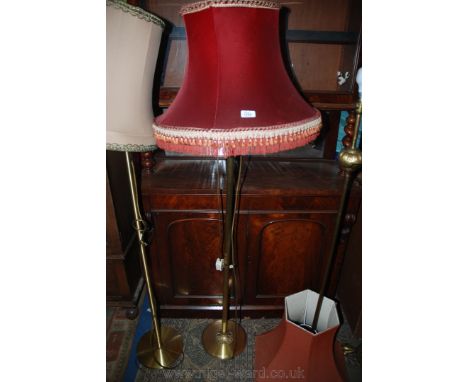 A very heavy telescopic Brass based Standard Lamp with fluted detail, standing on three fluted feet and wine coloured tassele